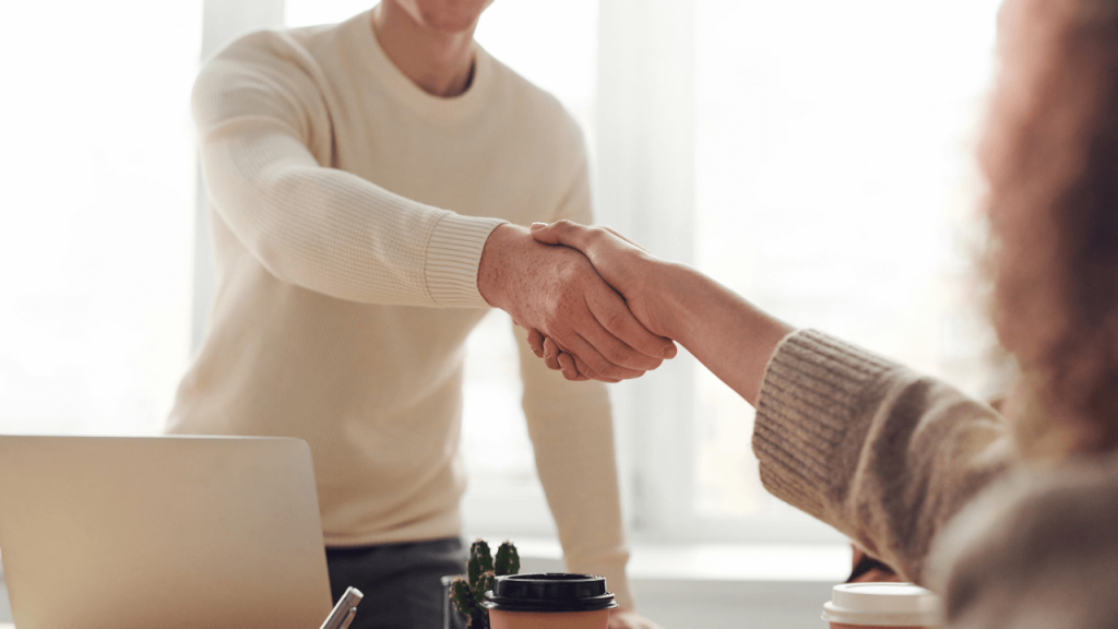 image of an interviewer shaking hands with the interviewee at an interview