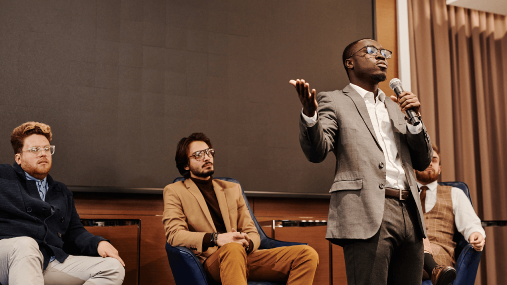 image of someone delivering a speech at a town hall meeting